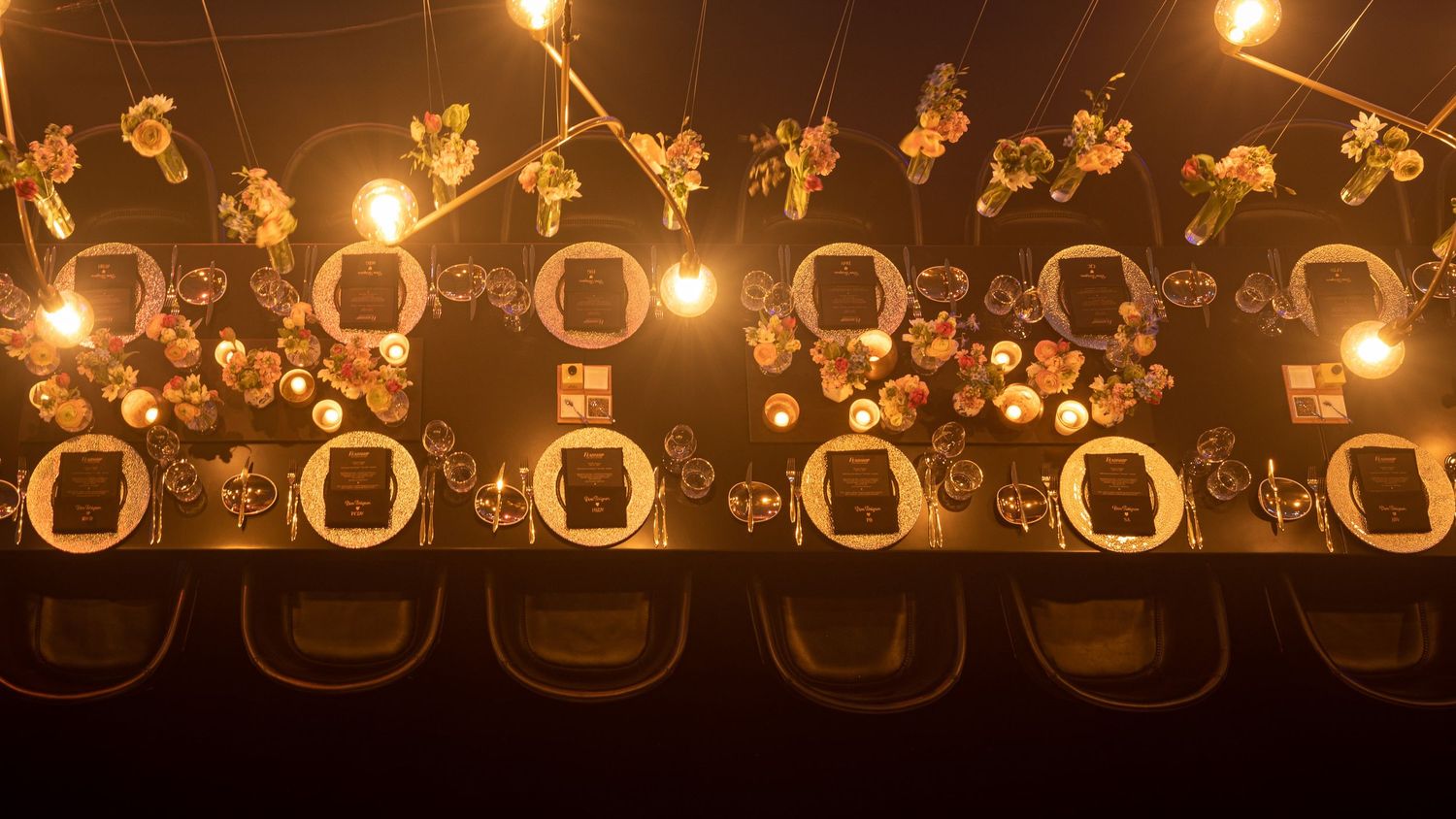 String lights illuminate a dark outdoor space creating a warm glowing ambiance against the night sky.