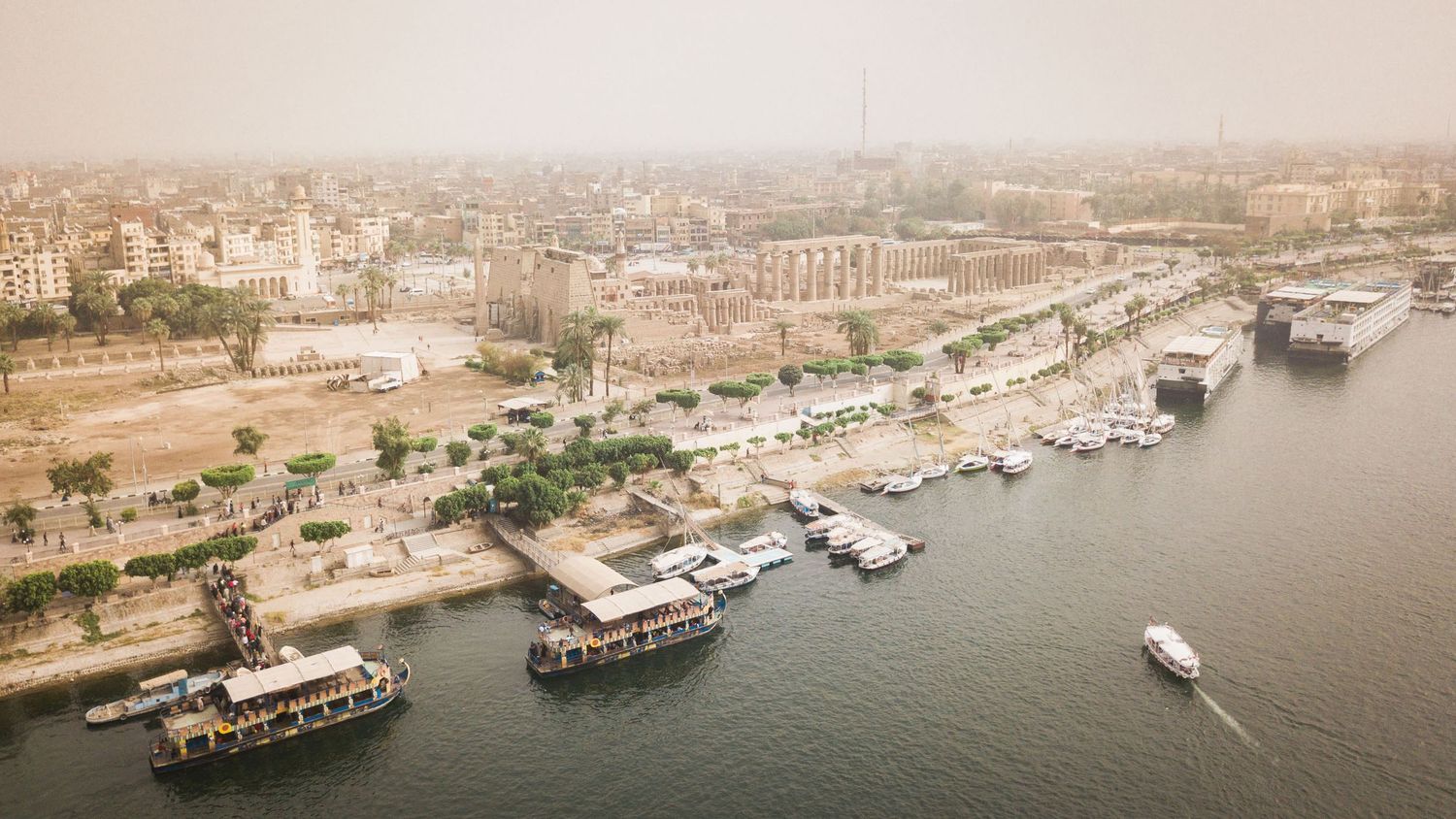 Panoramic aerial view of boats docked along the Nile River waterfront in Egypt.