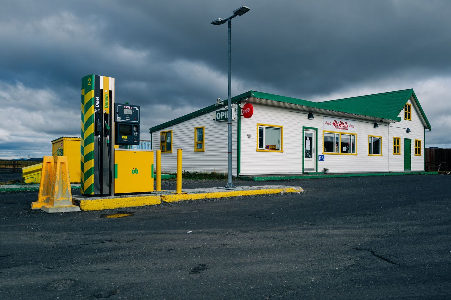 A series of minimalist architectural photos showing gas stations against moody skies with bold yellow and green elements.