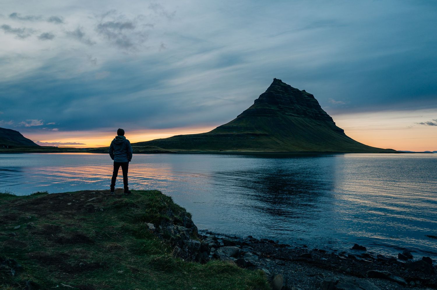 A dramatic panoramic series of sunset images at a coastal mountain landscape with silhouetted figures against the horizon.