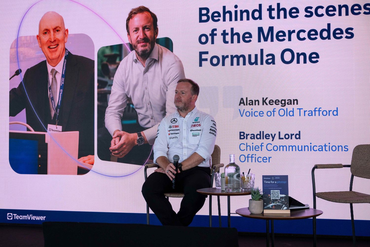 Behind the scenes presentation banner for Mercedes Formula One with corporate branding.