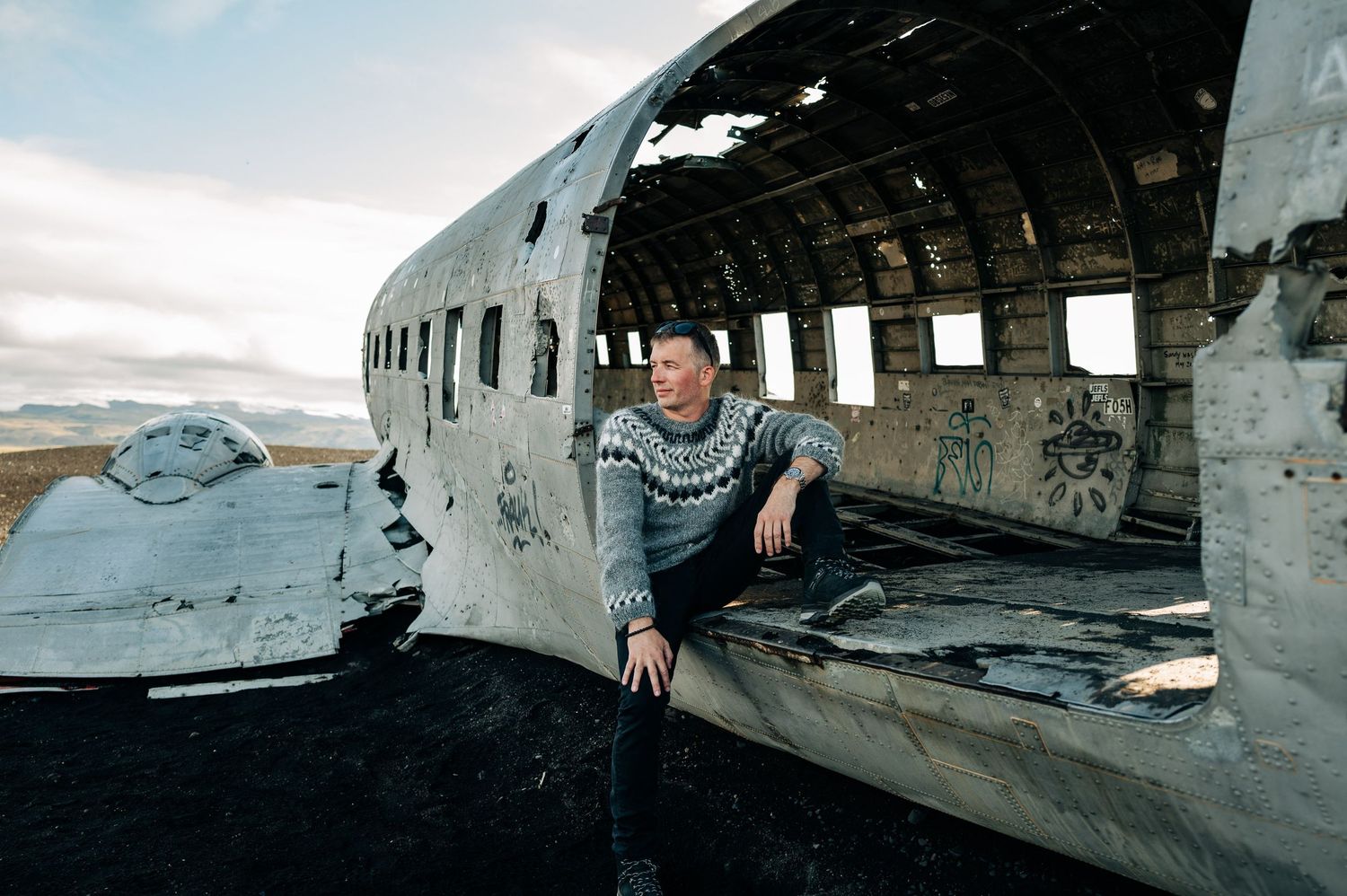 A series of five connected images showing an abandoned airplane wreckage in a desolate outdoor setting.