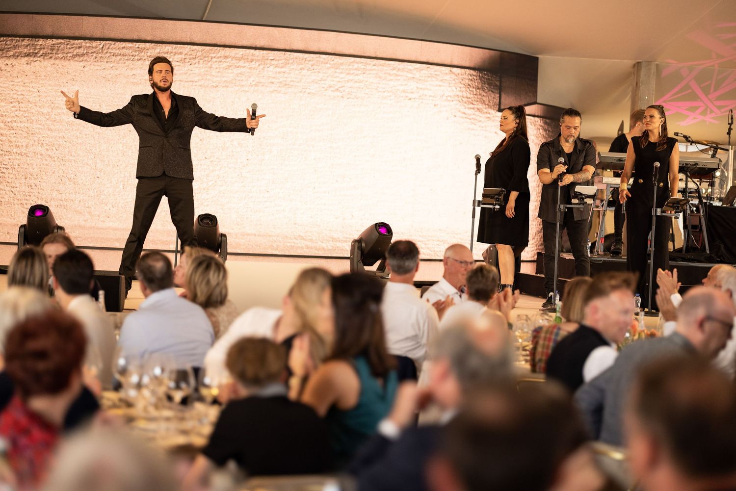 A performance venue with audience members watching an energetic stage presentation.