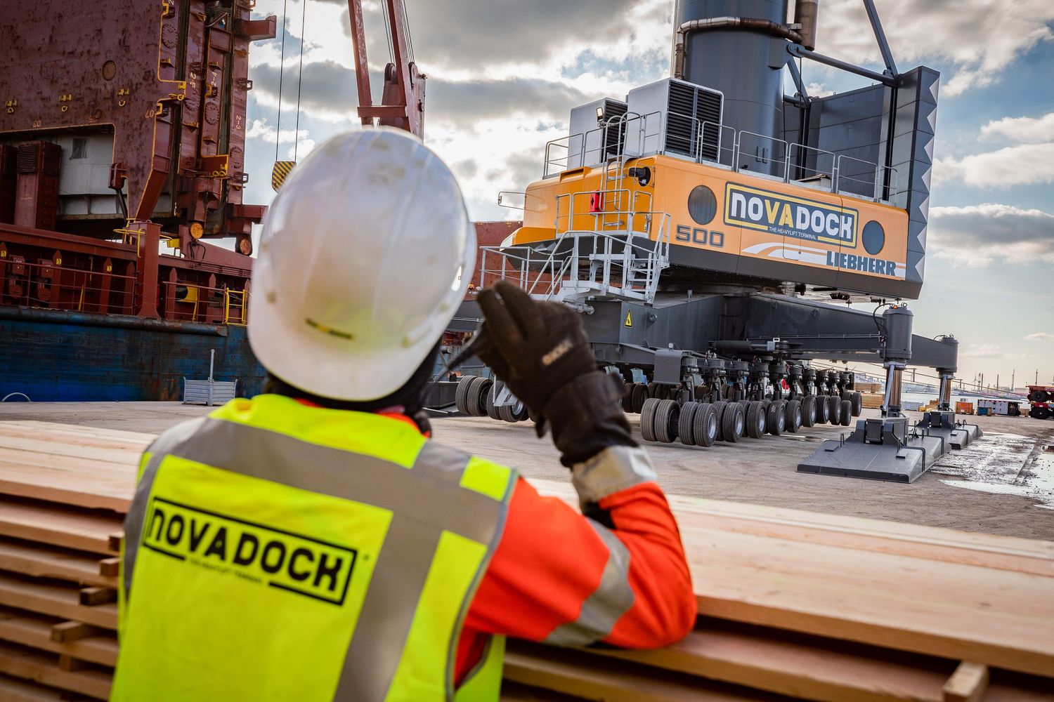 Workers in high-visibility gear inspecting cargo at industrial shipping port.