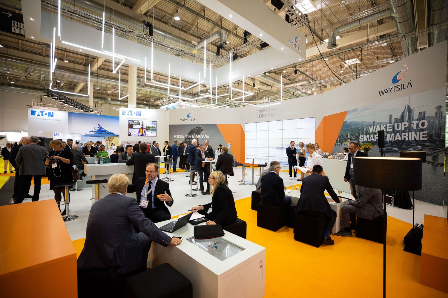 Interior view of a large modern retail store with clothing racks and bright orange flooring.