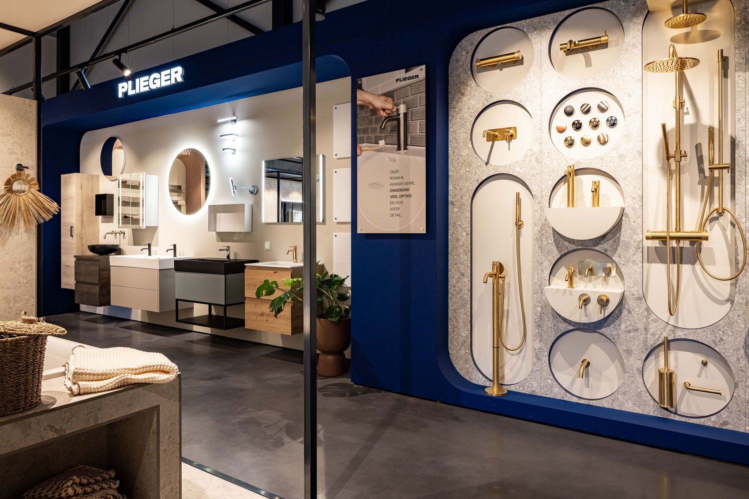 Modern bathroom showroom displays white fixtures and faucets against deep blue walls with elegant lighting features.