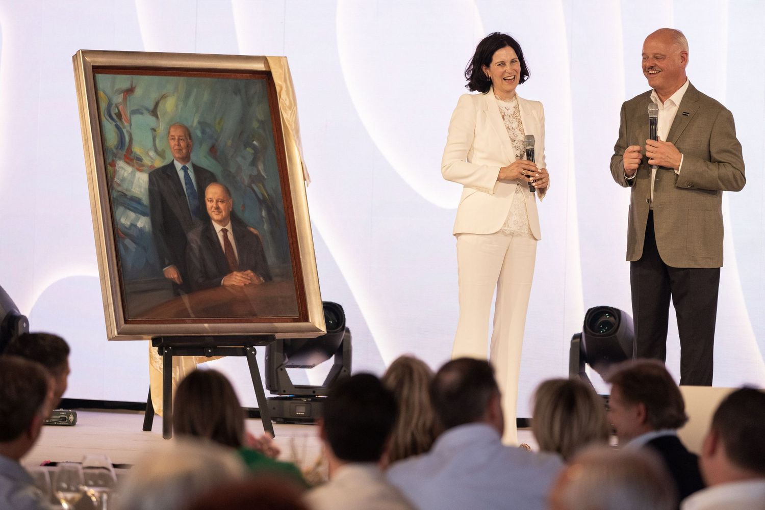 A series of connected photos showing people standing in an art gallery with framed portraits on white walls.
