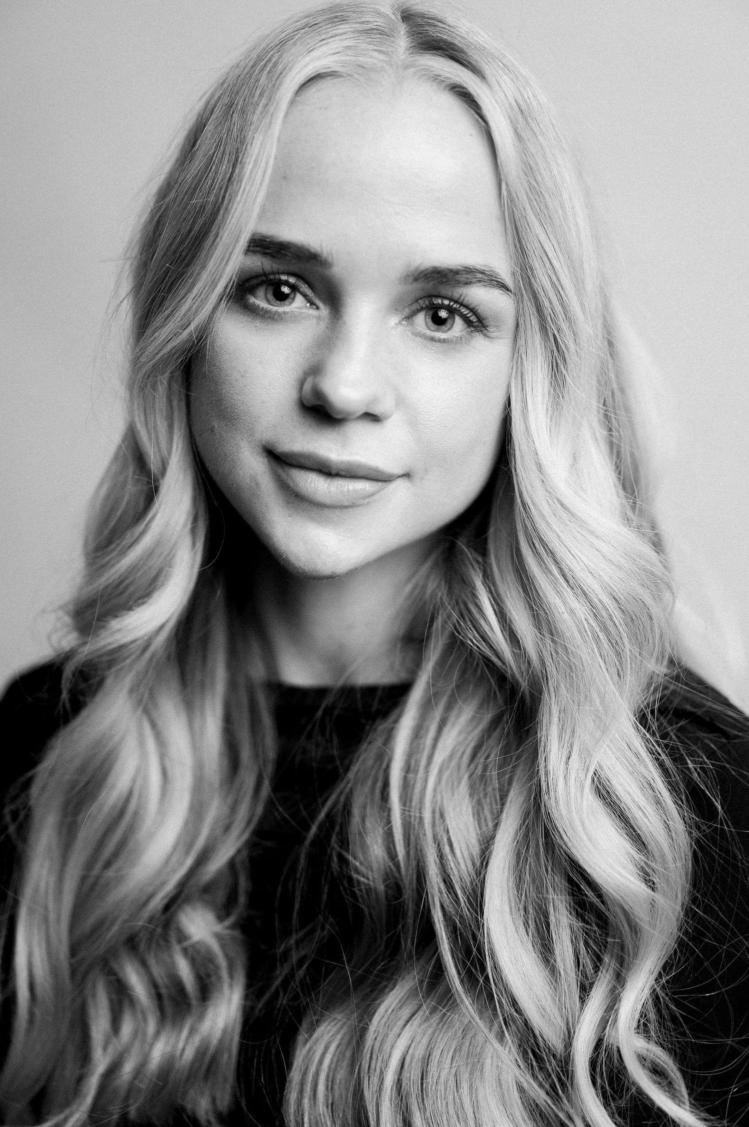 Black and white portrait series showing different expressions and angles.