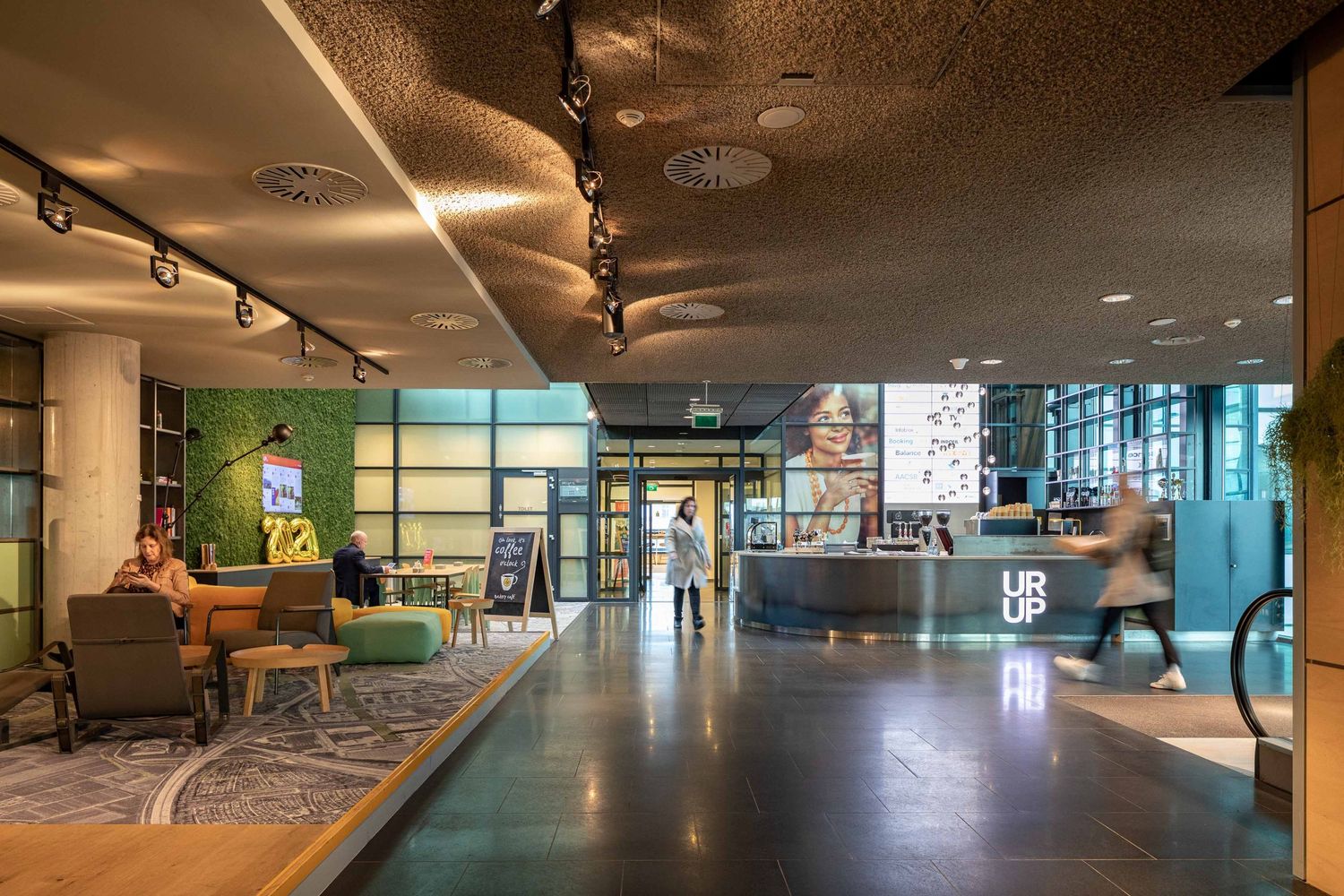 Modern office building interior with glass walls and sleek lighting showcases contemporary architectural design.
