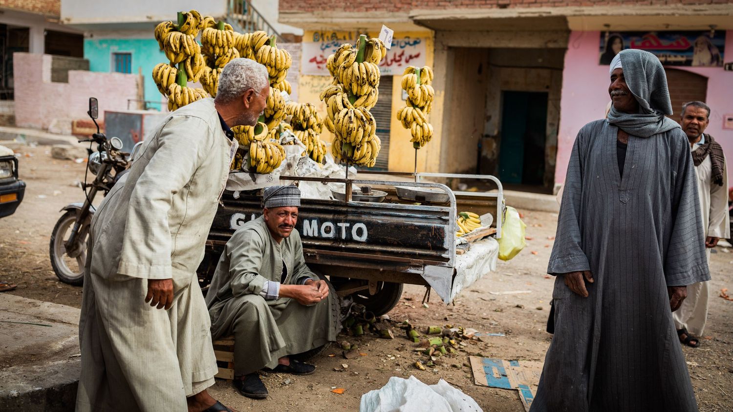 Market street scene with bananas and motorcycles in developing country.