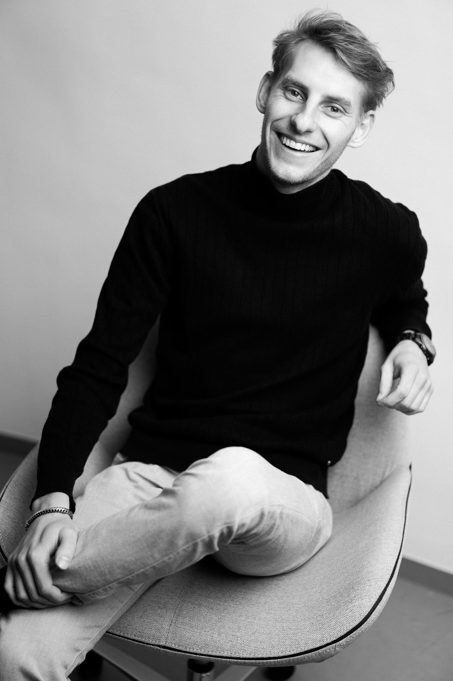 Black and white portraits showing relaxed poses in a studio setting.