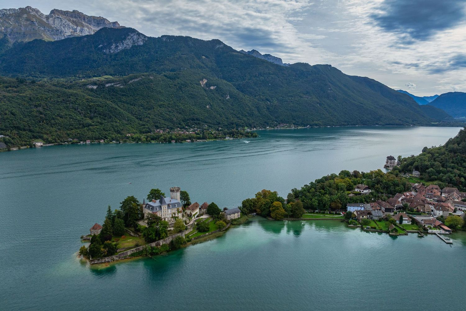 Dramatic mountain landscape reflects in the calm waters of an alpine lake.