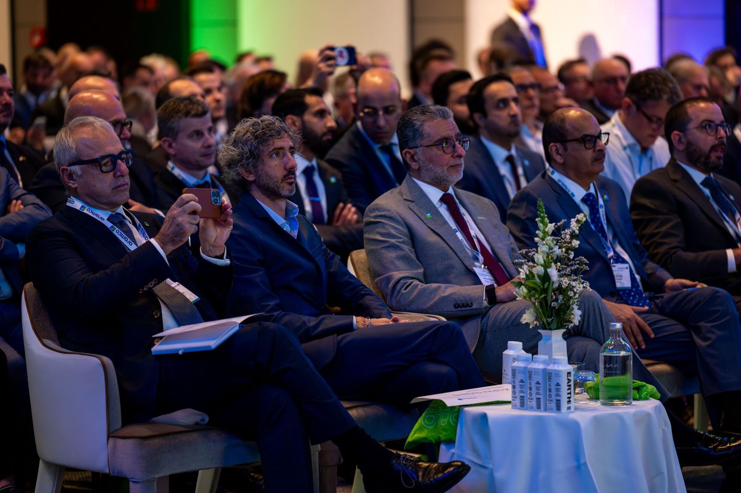Business conference audience seated in rows watching a presentation in an auditorium.