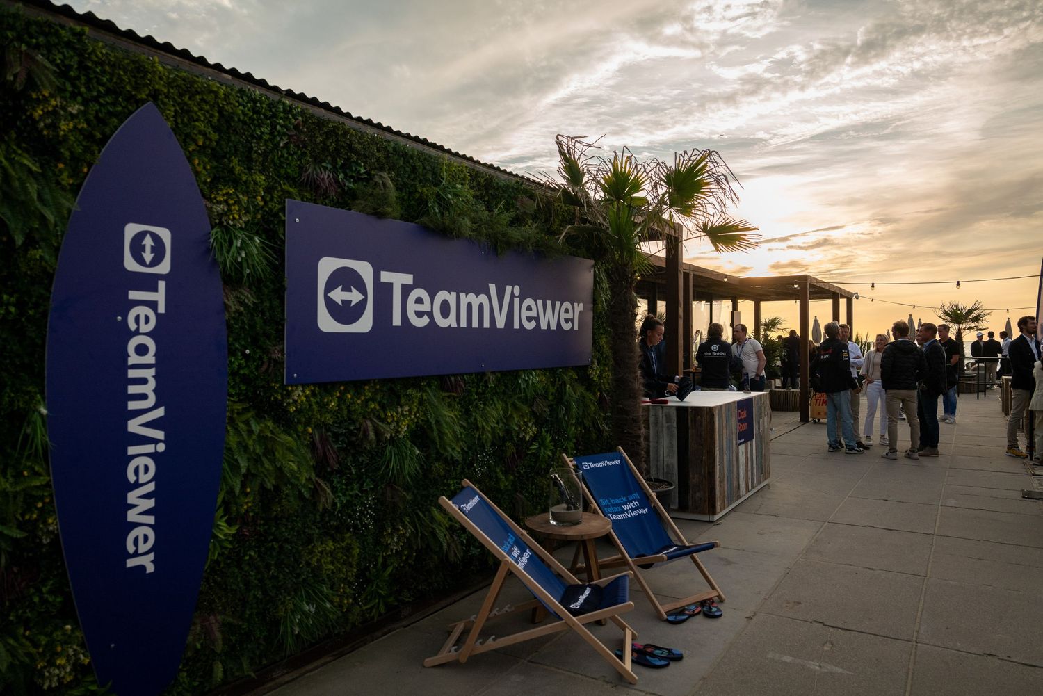 Outdoor venue setup with deck chairs against a sunset sky.