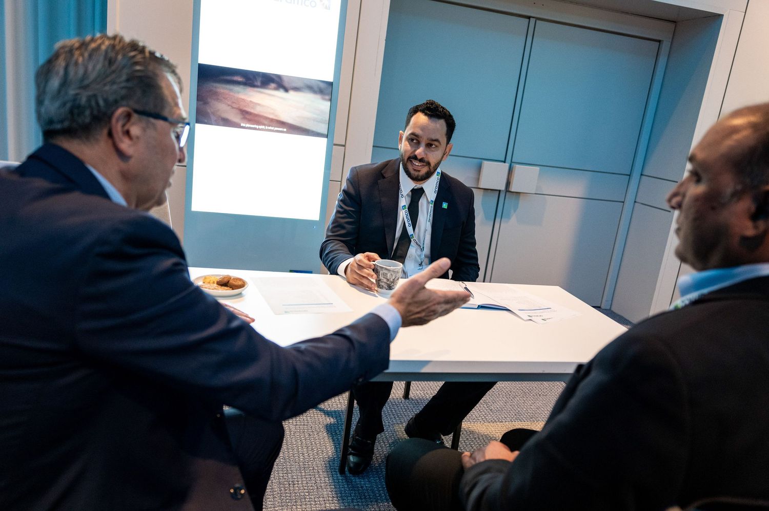 Business meeting in progress with participants seated around a conference room table.