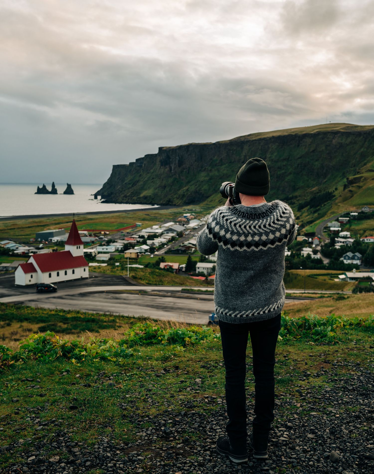 A panoramic series showing the dramatic coastal landscape of Vik, Iceland with its black sand beaches and basalt sea stacks.