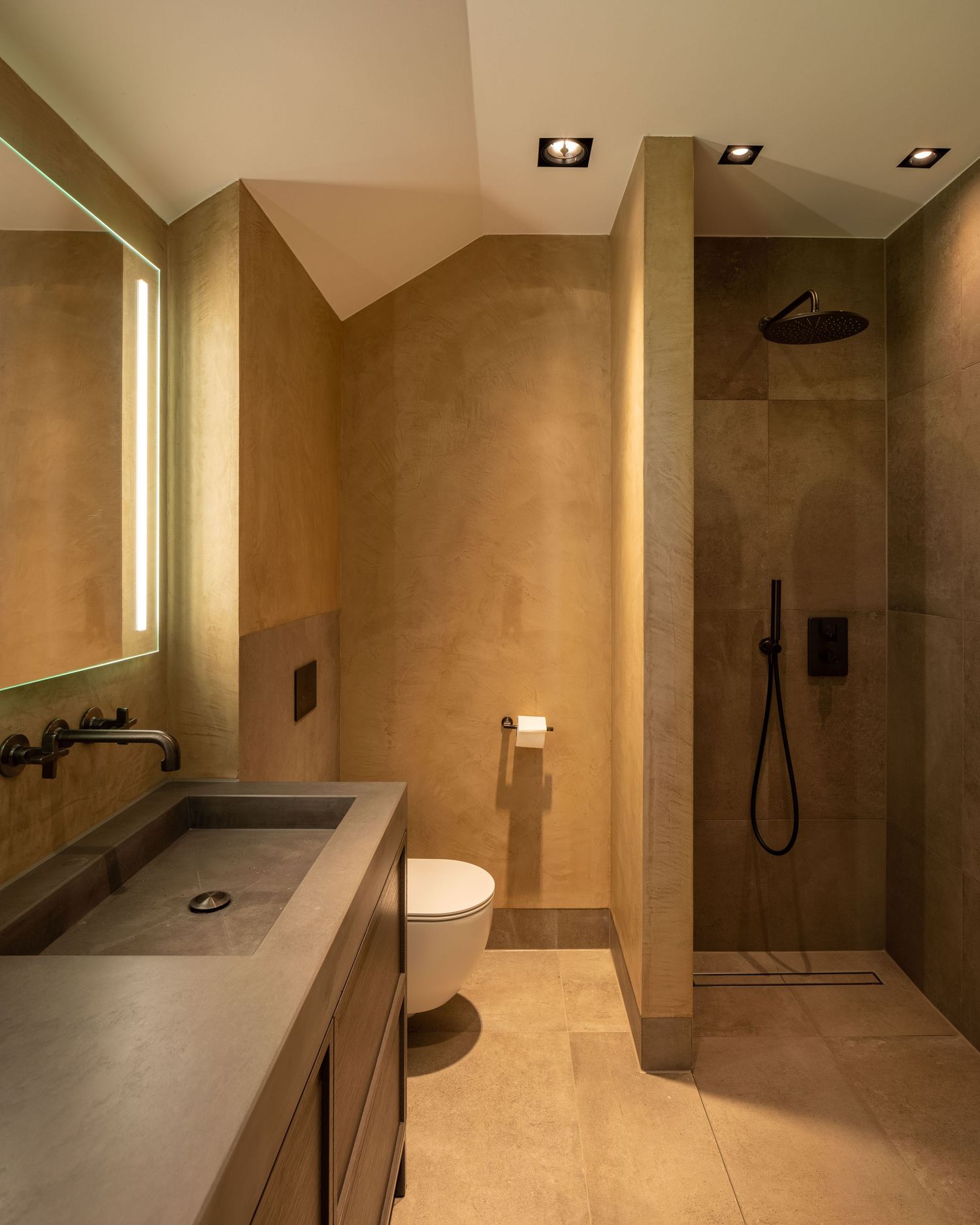 Luxurious beige bathroom featuring modern fixtures, walk-in shower, and sleek vanity design.
