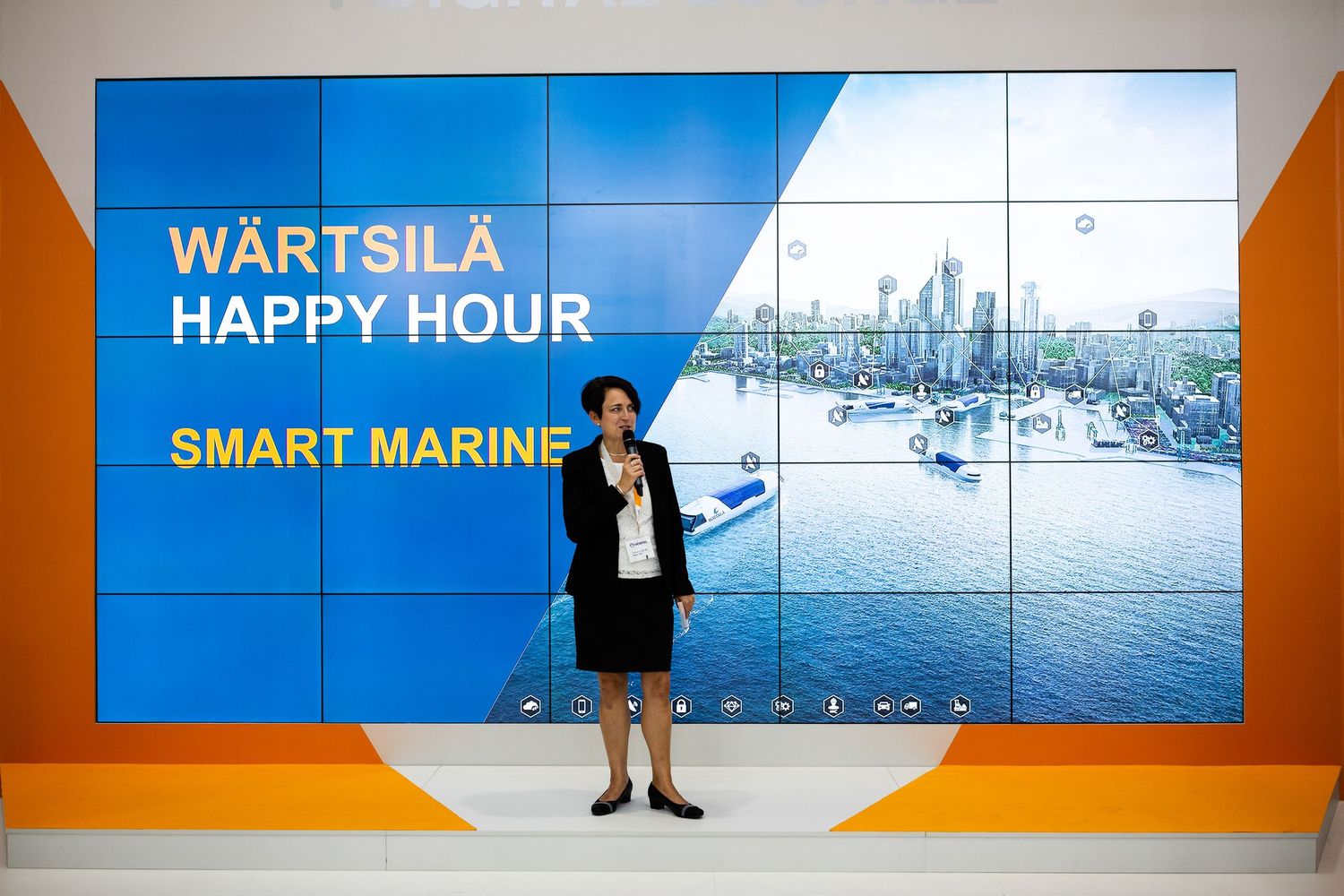 Digital displays showing Wärtsilä Smart Marine technology presentations at a corporate event.