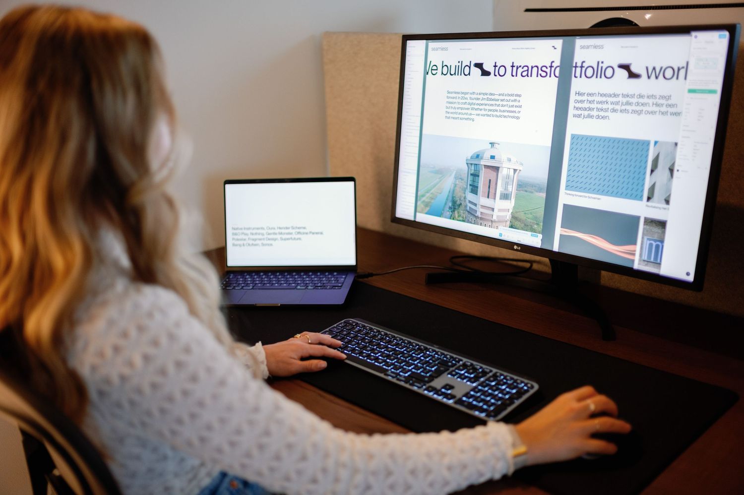 Person working at computer desk with multiple monitors in home office setting.