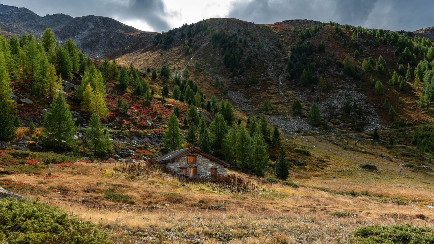 Dramatic mountain panorama showing rugged peaks and valleys under cloudy skies.