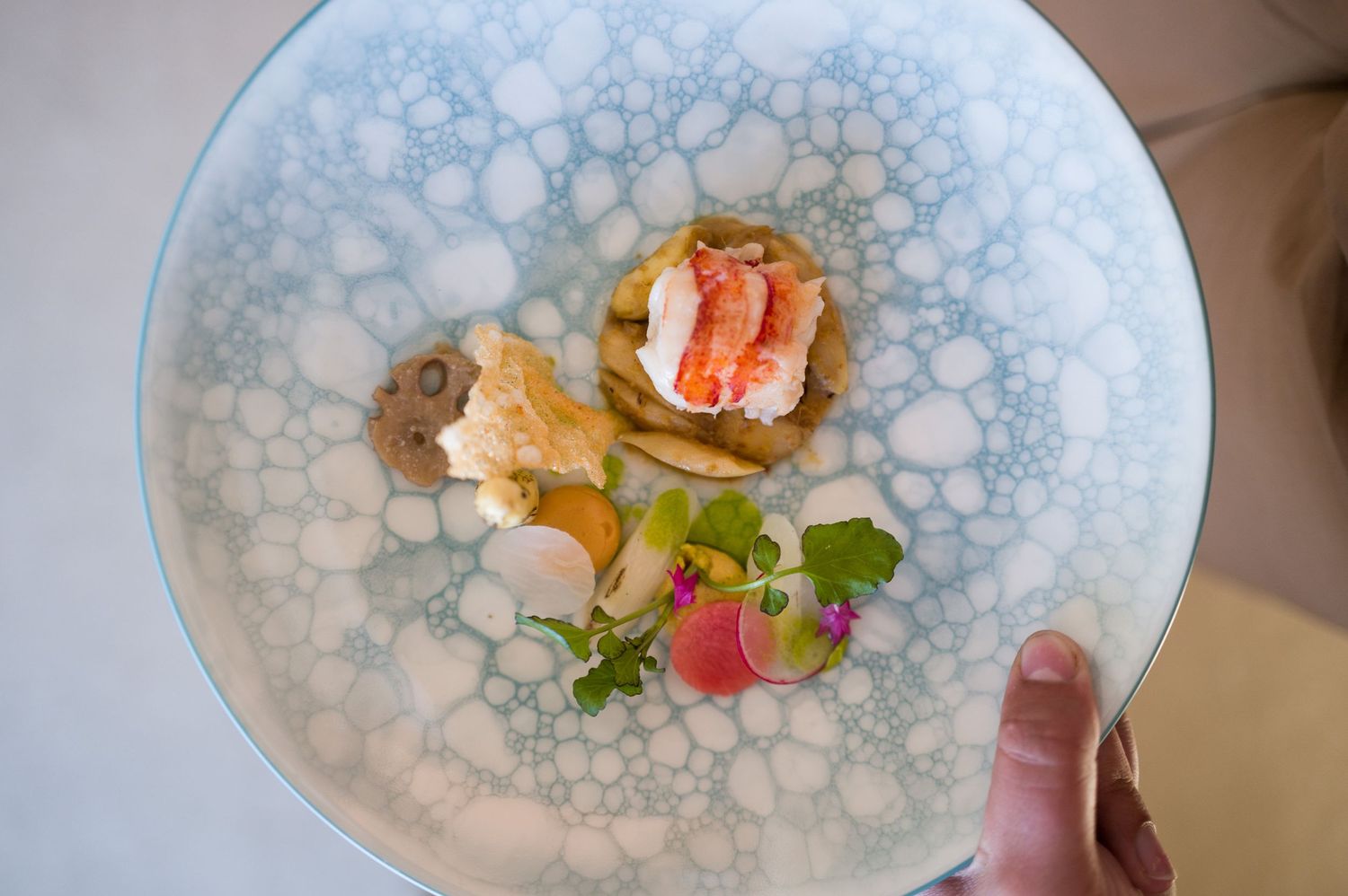 A series of elegant plated dishes on decorative blue and white porcelain plates.
