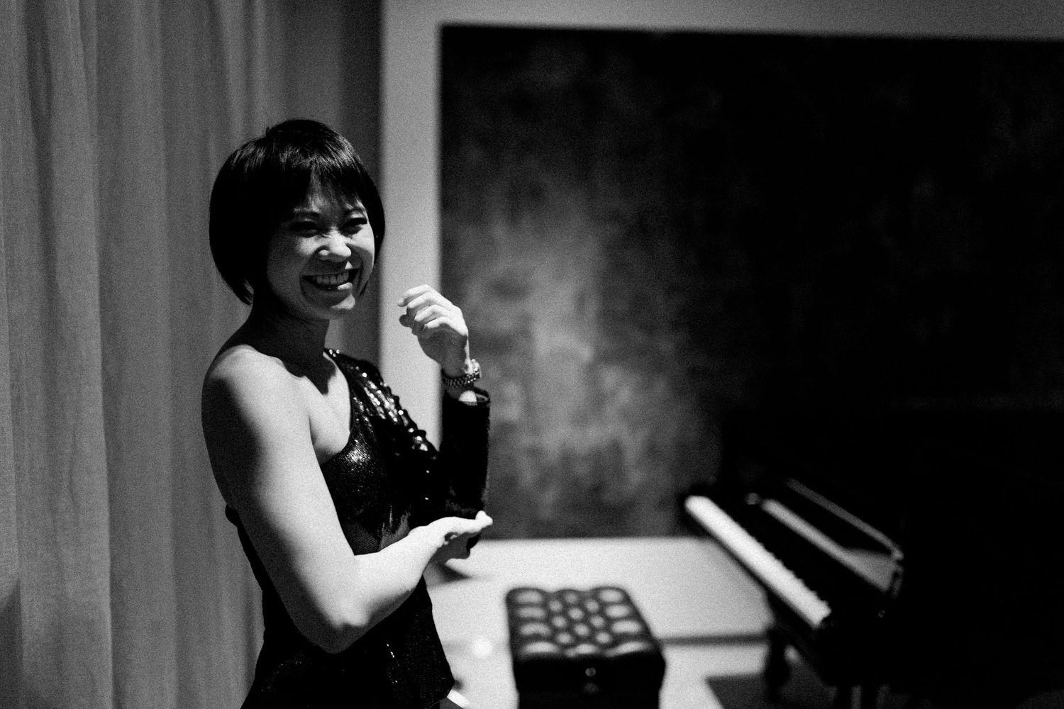 A series of black and white photographs showing someone performing on stage with dramatic lighting effects.