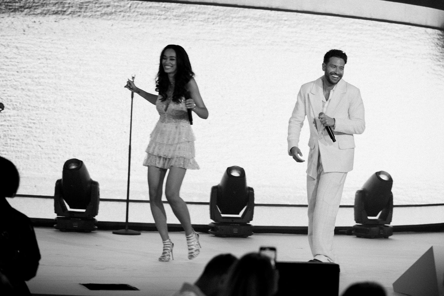 A black and white photo sequence showing people performing various dance moves against a white wall.