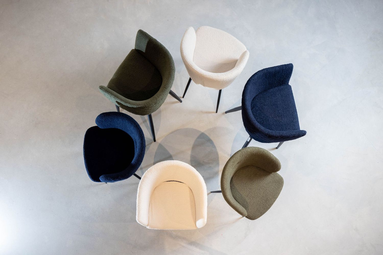 A collection of baseball caps and trucker hats arranged in a row against a light gray background.