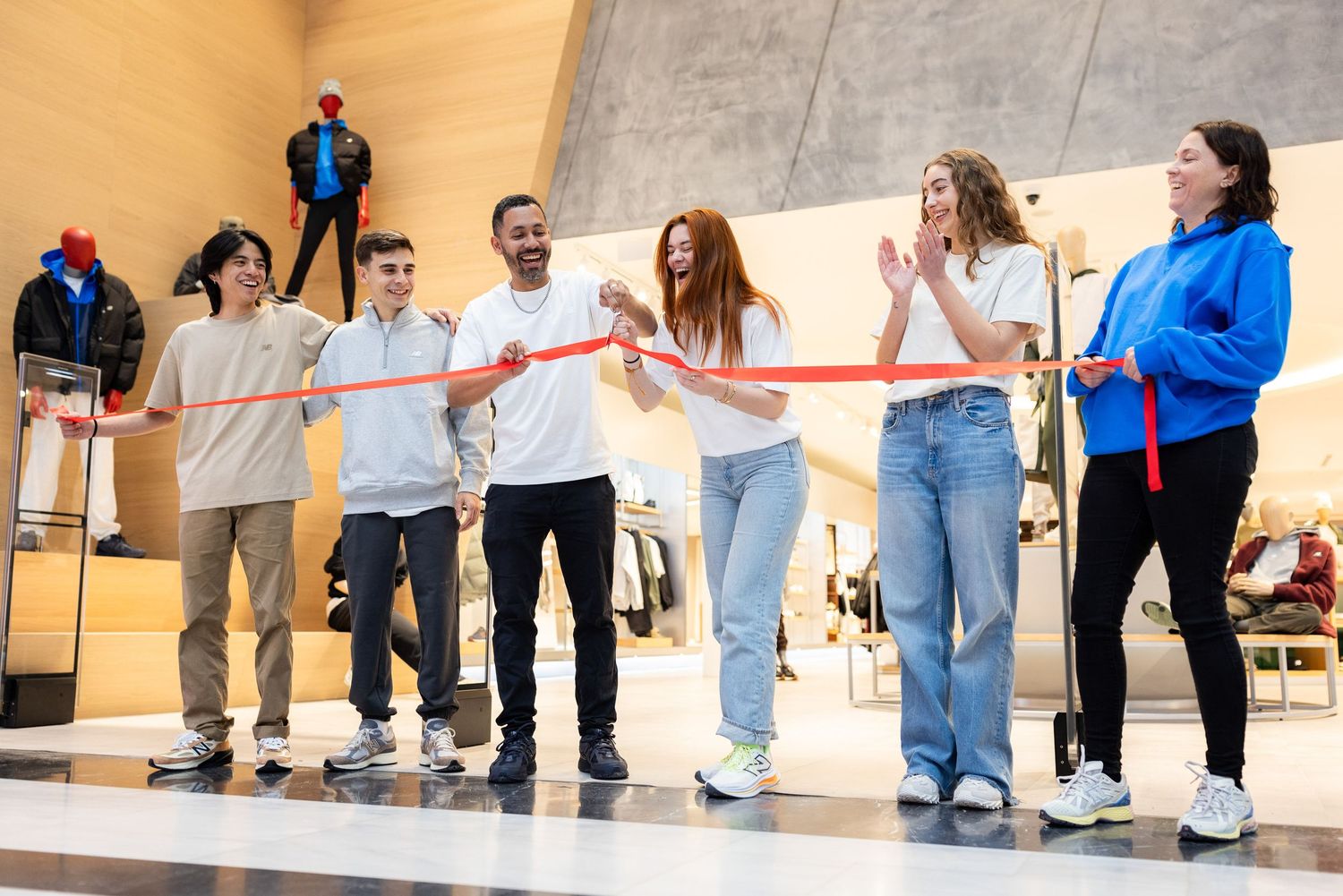 Large group of people standing in line formation during an indoor event or presentation.