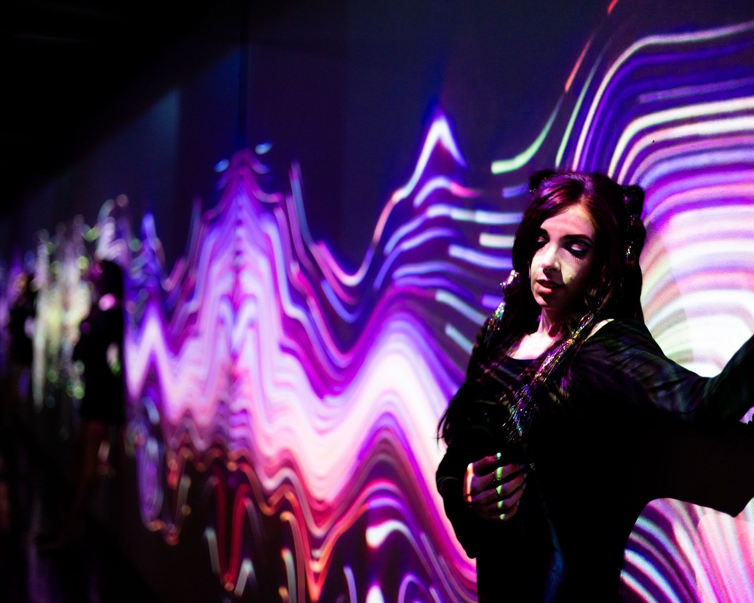 lady in a wave of colored lights