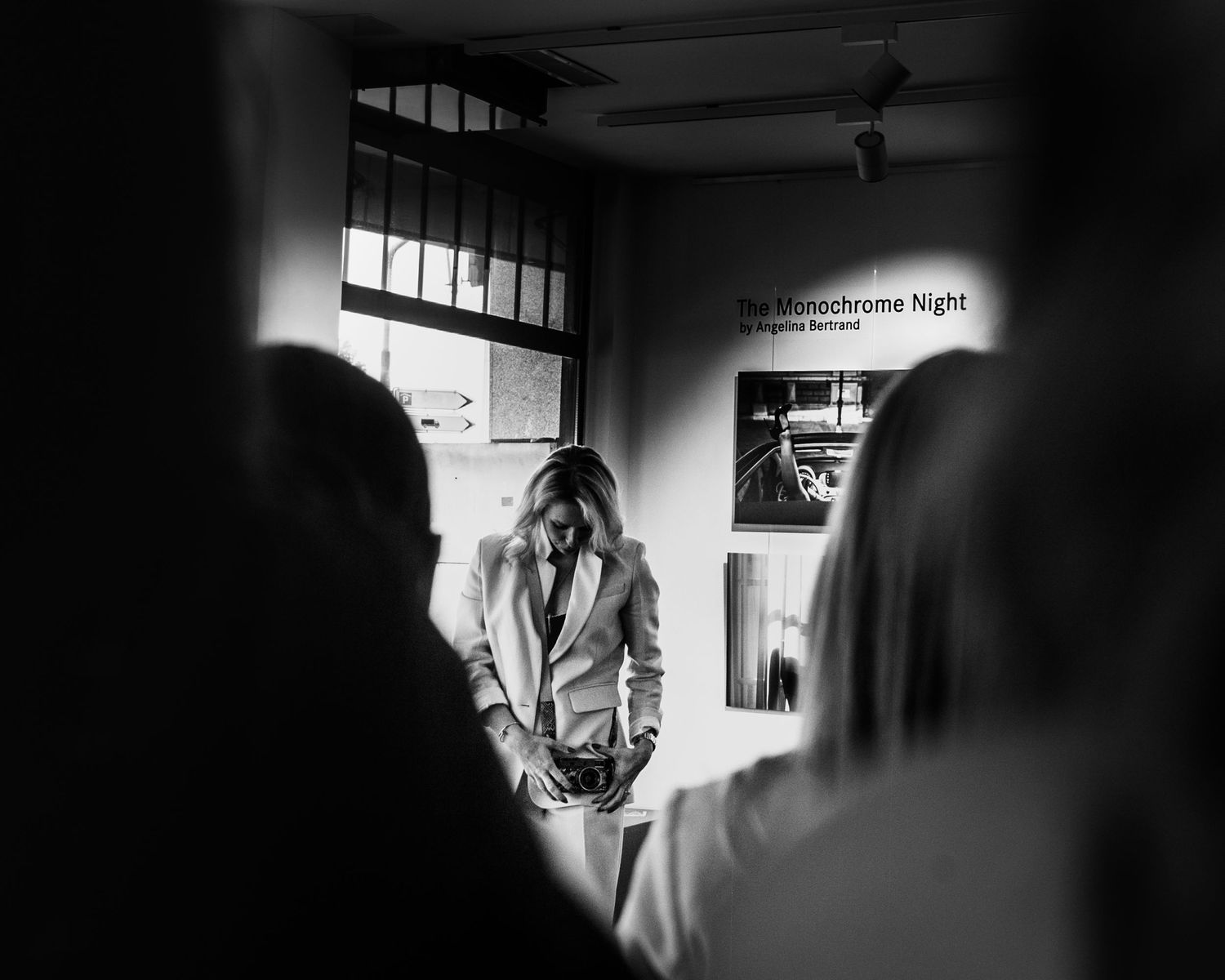 Black and white photo of a woman in a blazer at The Monochrome Night photography exhibition.