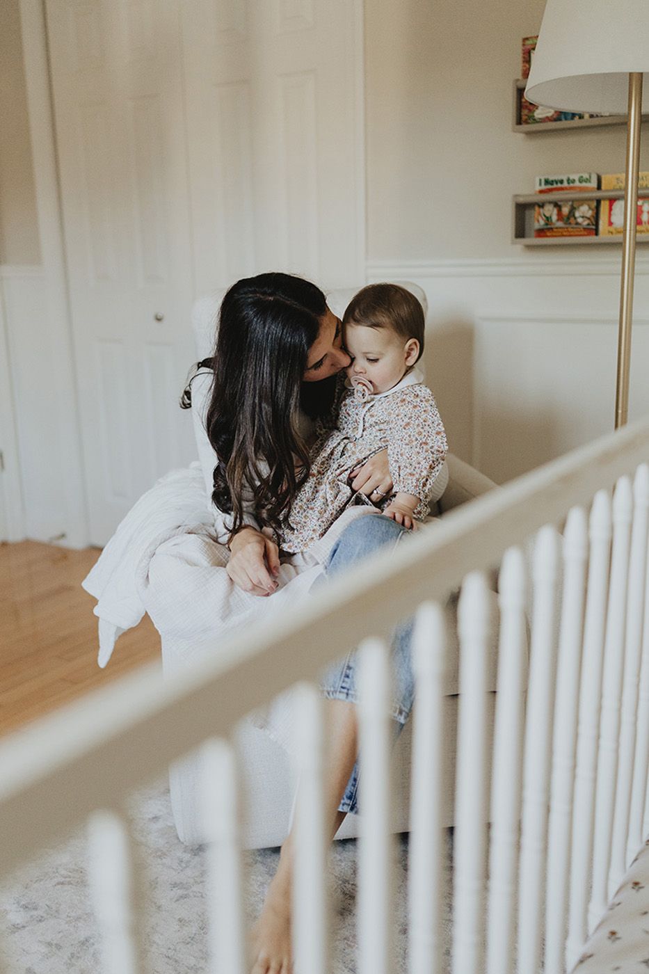 A mother rocks her baby girl in the nursery during family photos in Fredericton, New Brunswick