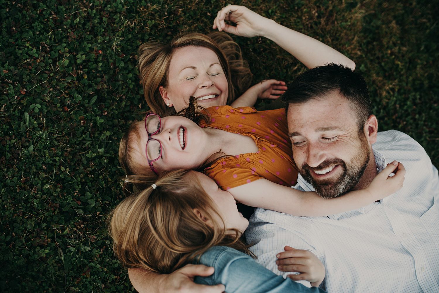 A family cuddles and laughs together during family photos in Fredericton, New Brunswick