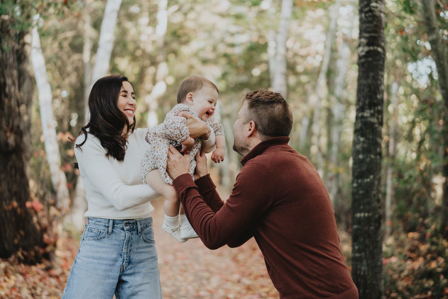 A couple play with their baby girl during family photos in Fredericton, New Brunswick