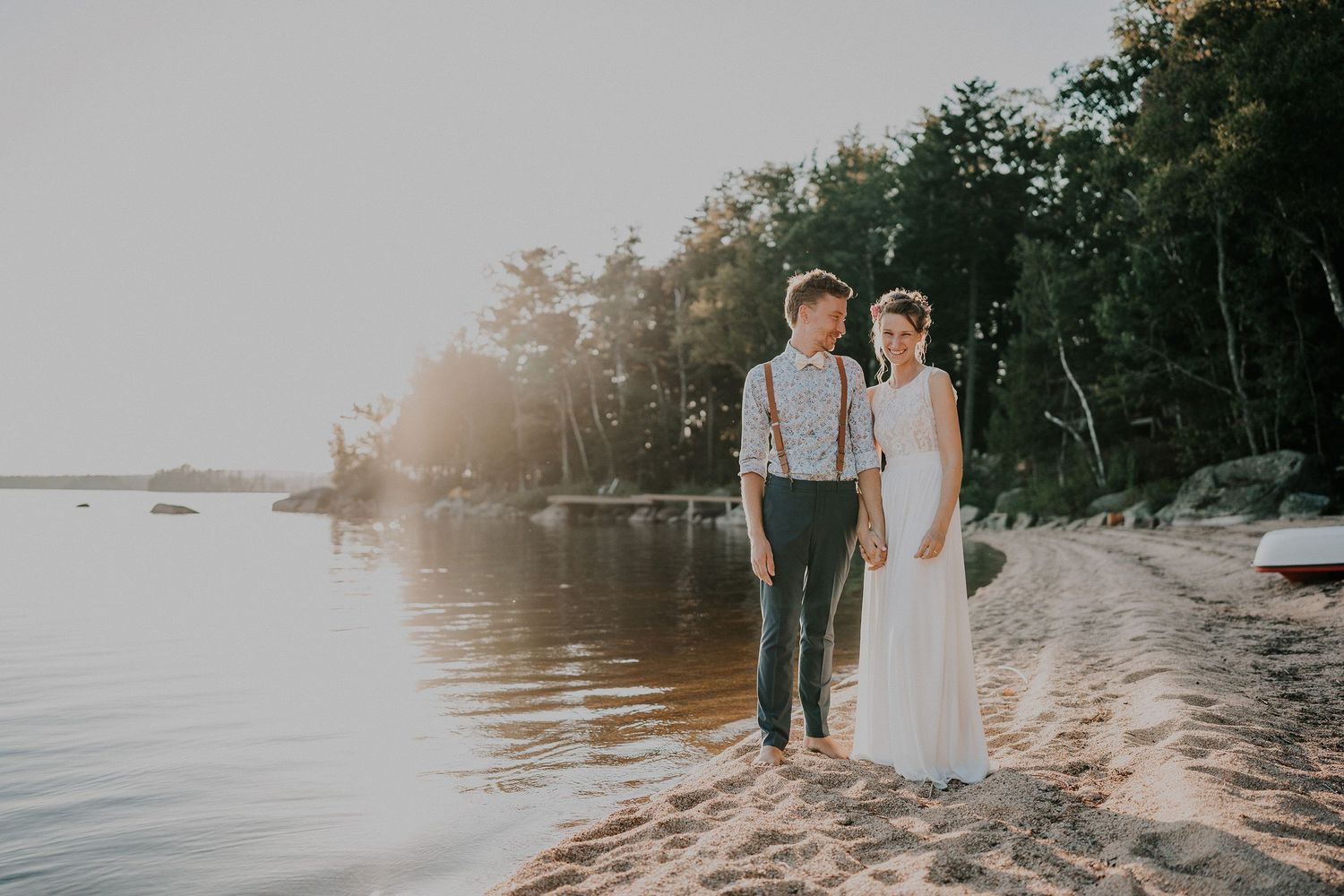 Bride & groom on the beach on their wedding day at Lake Magaguadavic, New Brunswick.