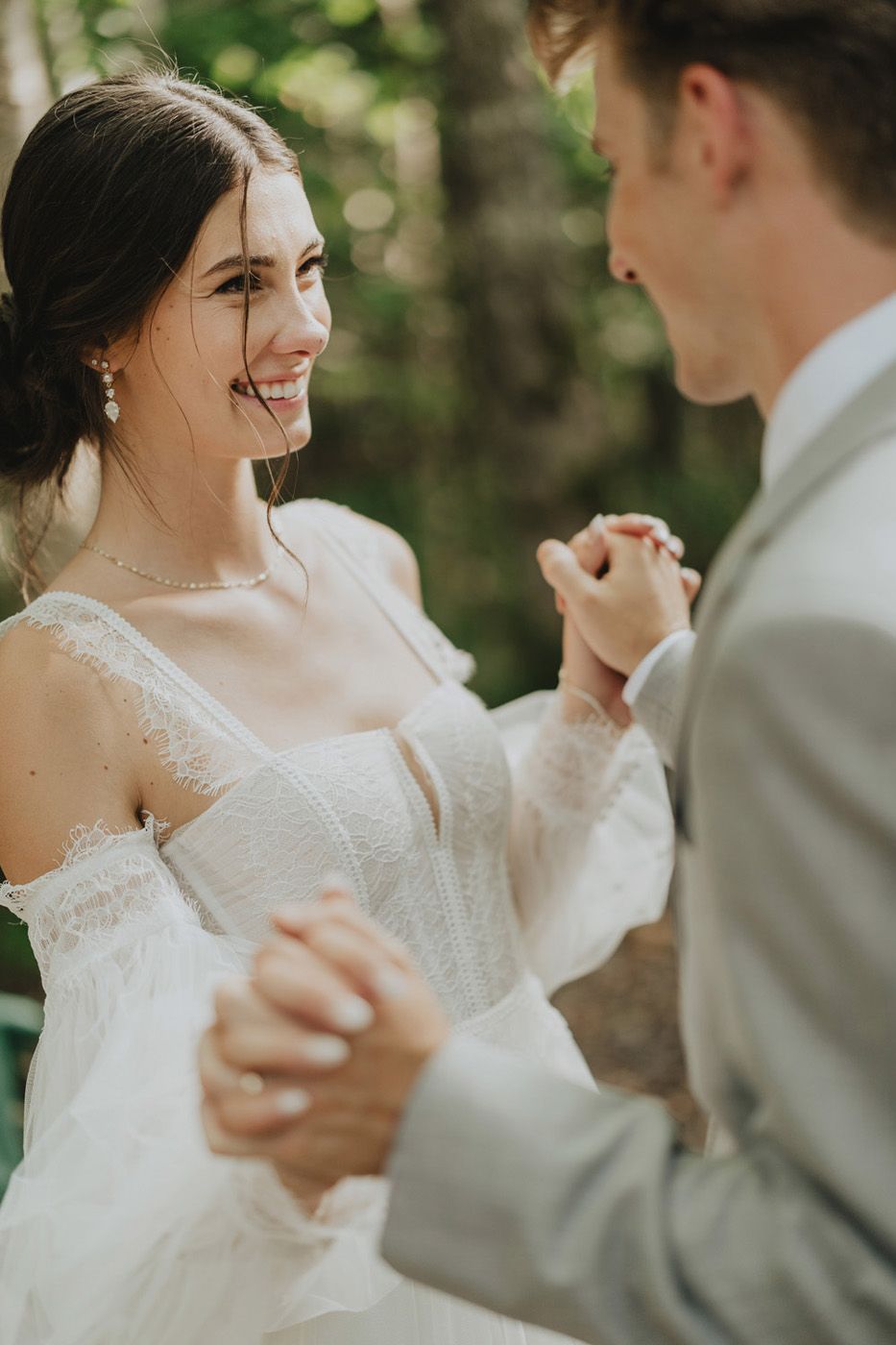 Couple hold hands after their outdoor wedding at Shiktehawk Bible Camp near Florenceville, Bristol, New Brunswick.