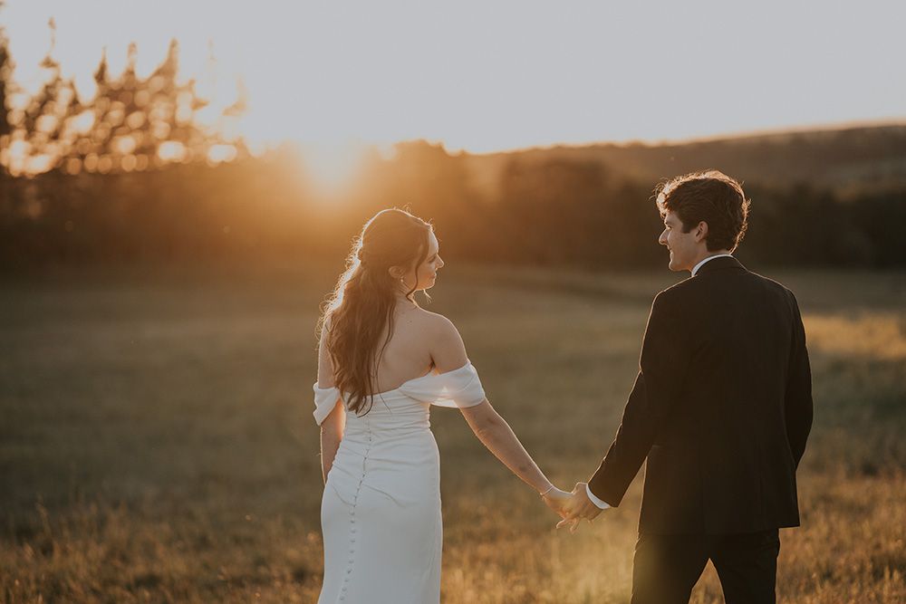 Married couple enjoying sunset at their wedding at the New London Carriage House in New London, PEI