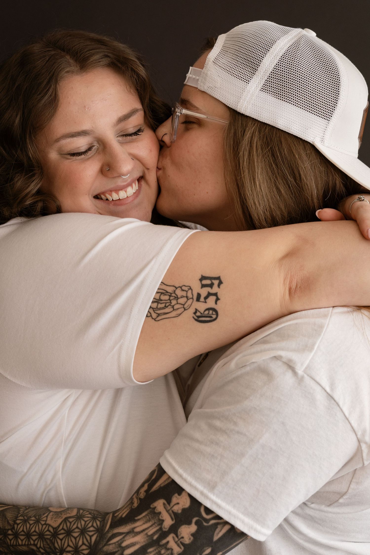 Intimate black and white portrait series showing affectionate moments between couple.