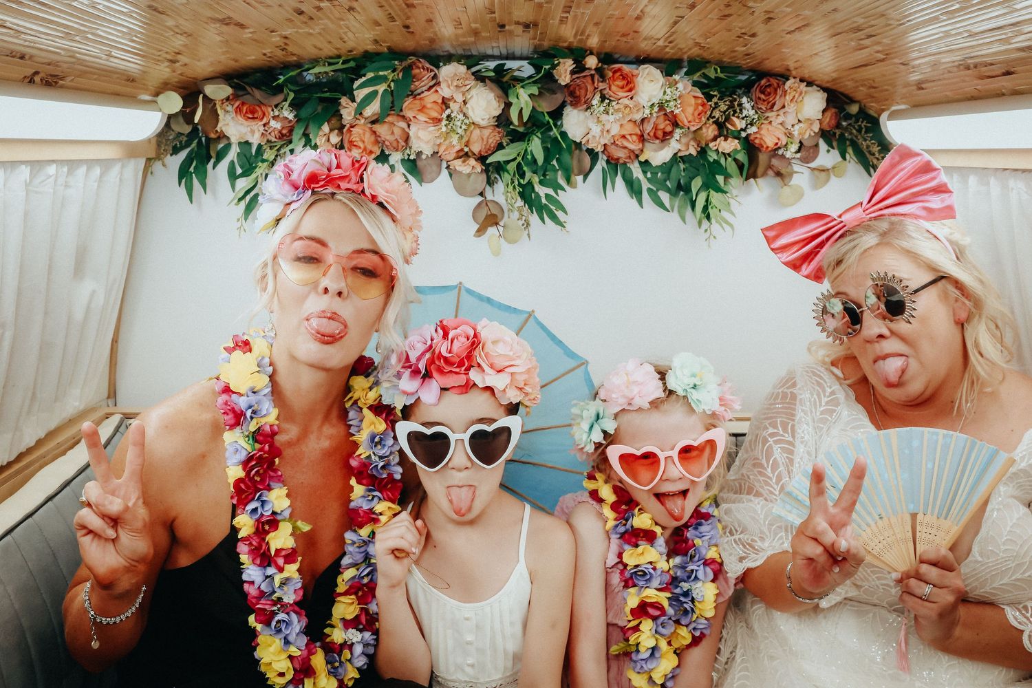 Elegant floral photo booth backdrop featuring lush greenery and soft blooms, perfect for weddings and celebrations.