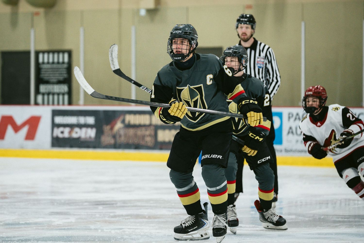 Hockey players battle for position during an intense game moment on the ice.