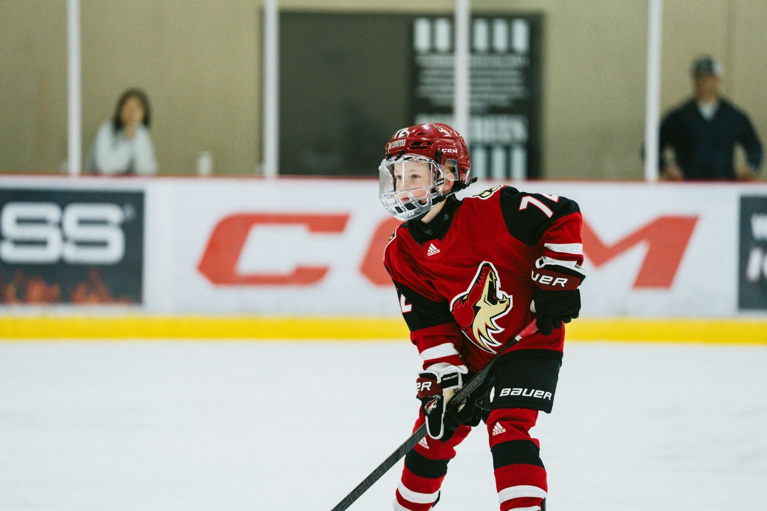 Hockey players battle for puck control on the ice during a fast-paced game.