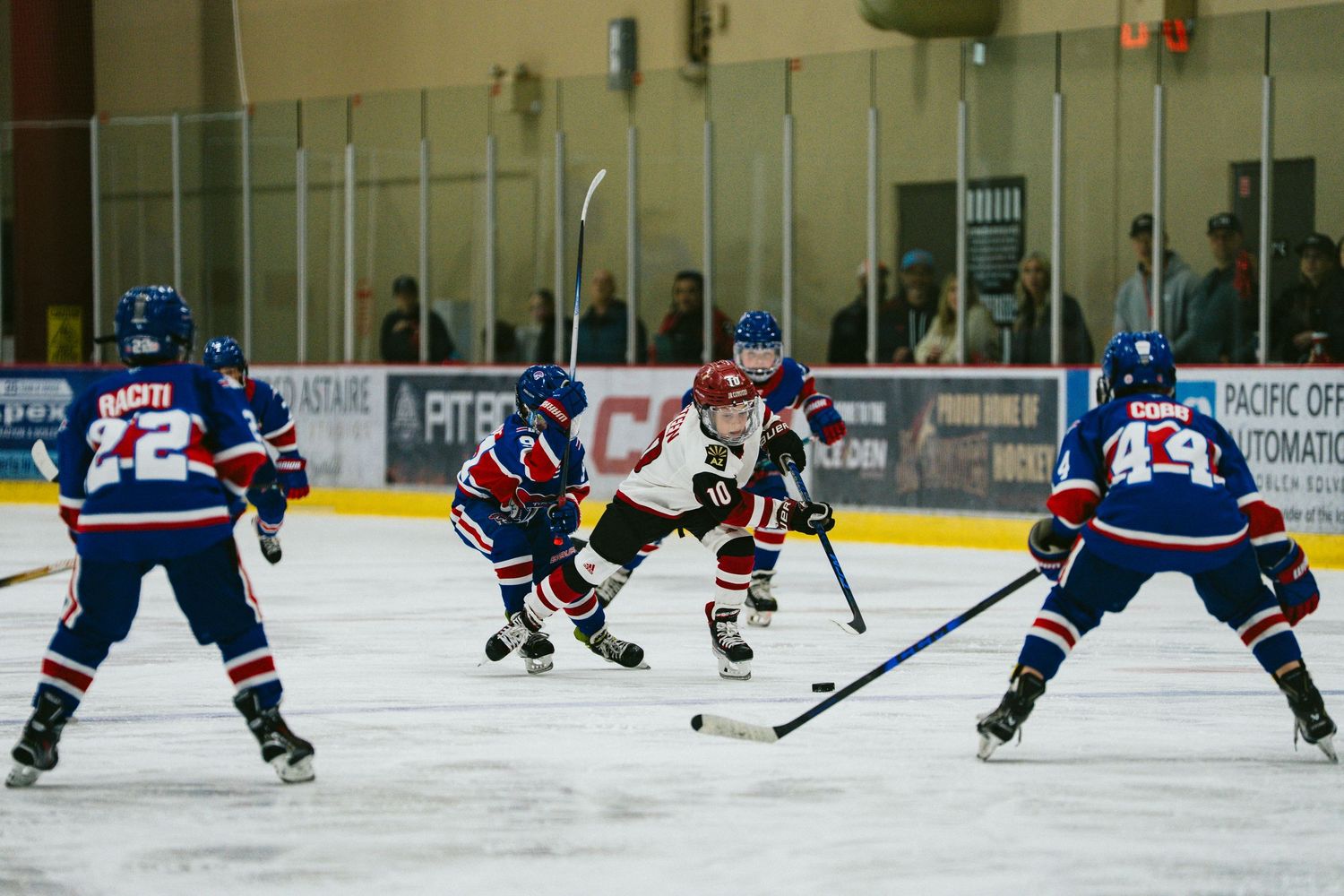 Wide view of an ice hockey rink showing players from both teams during gameplay.