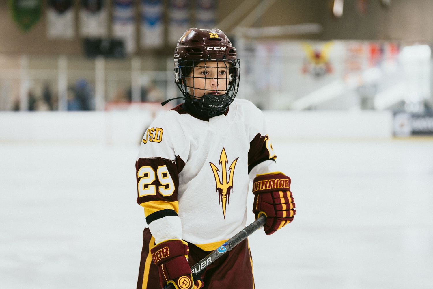 Arizona State Sun Devils hockey player #29 in white jersey holding a stick on the ice rink.