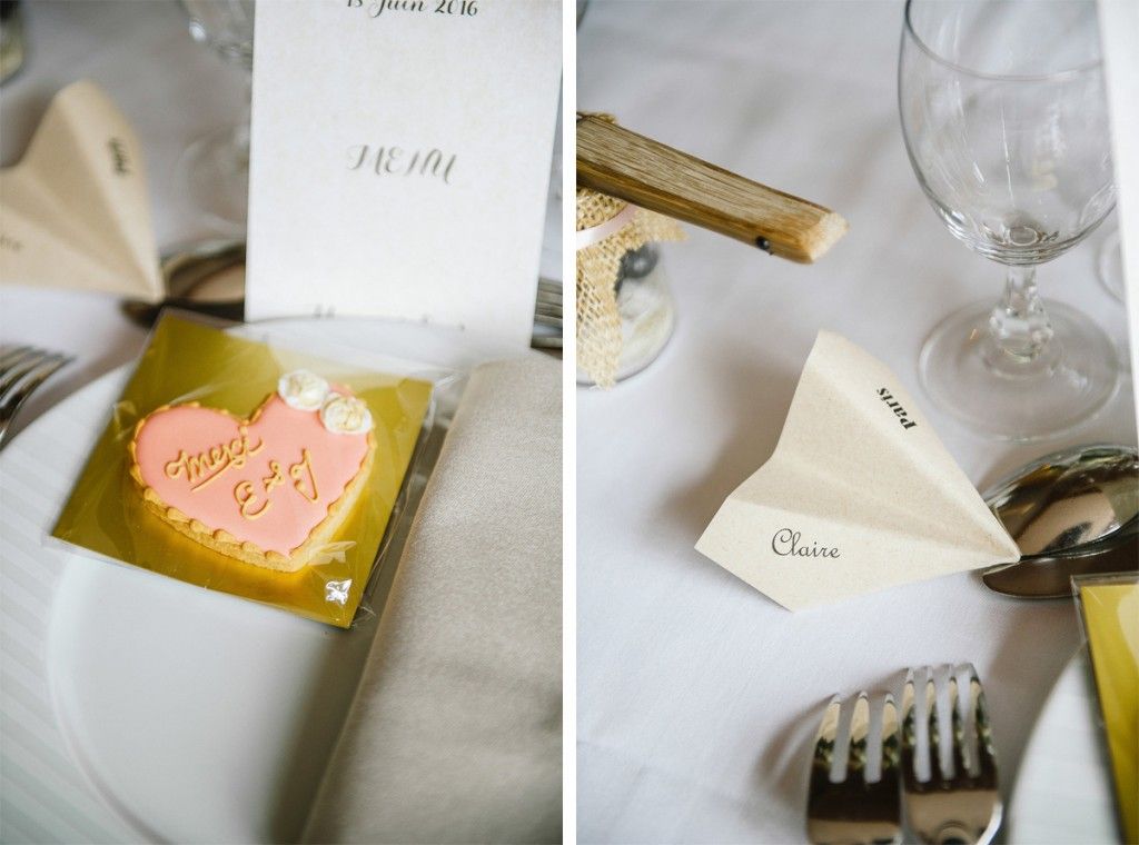 Wedding place settings featuring heart-shaped personalized cookies and paper airplane name cards.