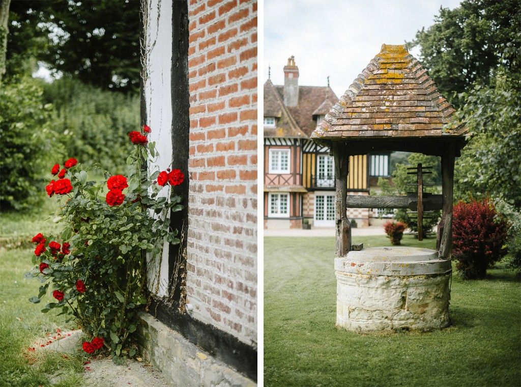 Charming French countryside venue with red roses and stone well in lush garden.