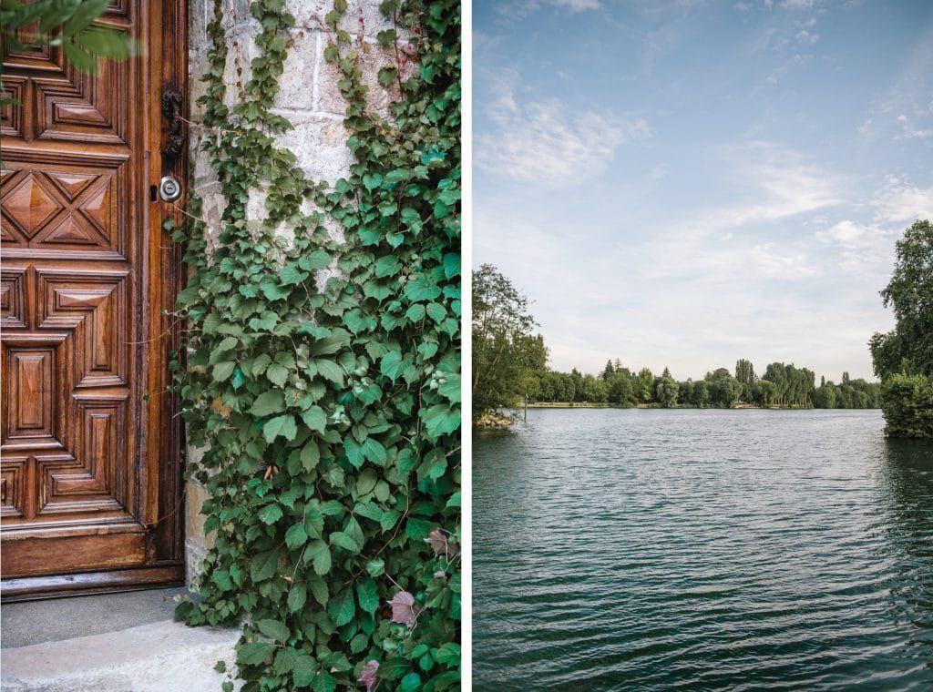 Elegant carved wooden door covered in green ivy vines beside a serene lakeside view on a sunny day.