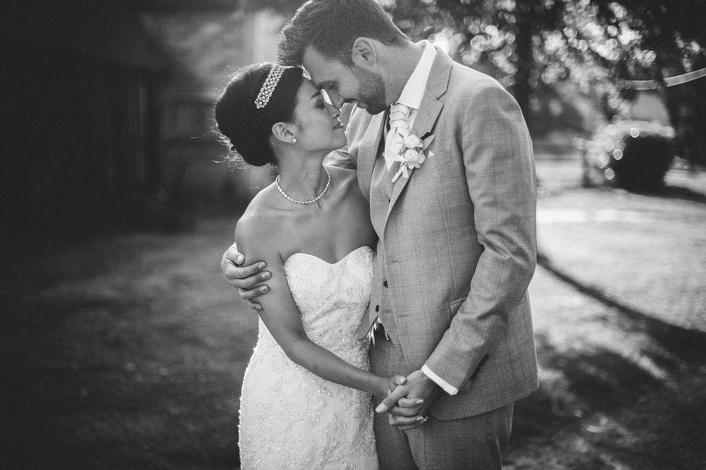 Black and white close-up of bride and groom sharing an intimate moment on their wedding day.