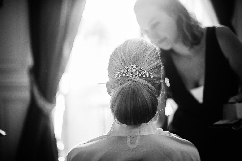 Black and white image of bride with elegant updo adorned with a crystal hair piece.