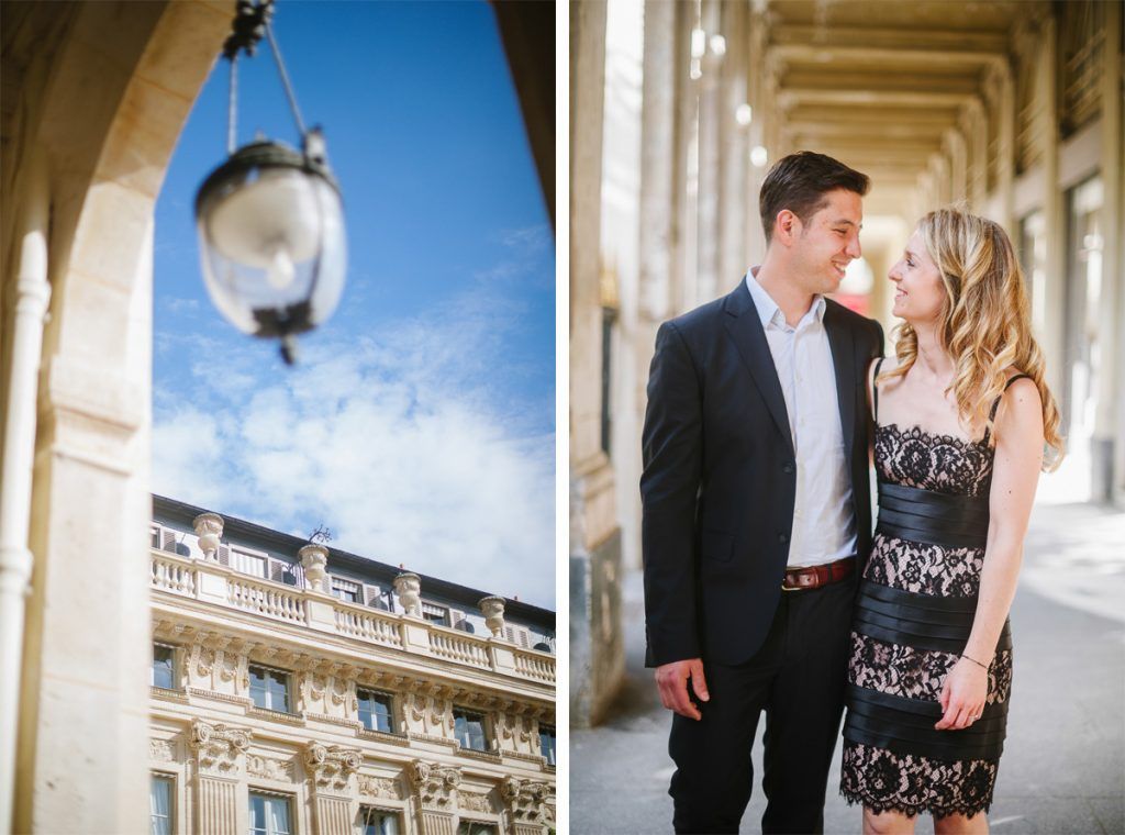 Couple sharing a tender moment under ornate arched colonnades of a grand Parisian building on a sunny day.