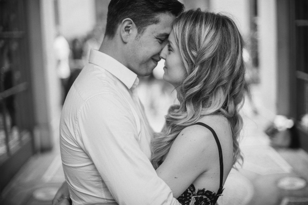 Intimate black and white close-up of a couple about to kiss, capturing a tender romantic moment in Paris.